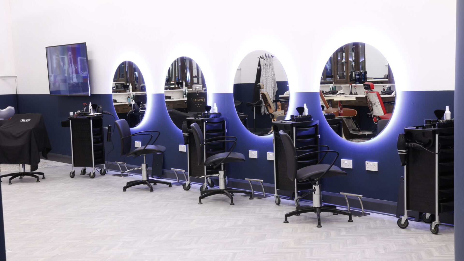 barbers chairs in front of mirrors